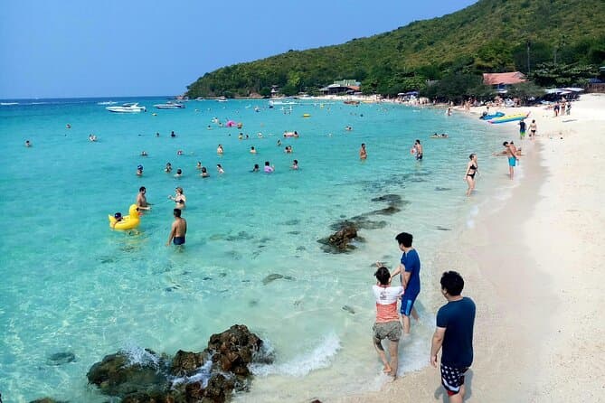 Coral Island Koh Larn turquoise water clear beach with parasailing and water sports Pattaya Thailand day trip