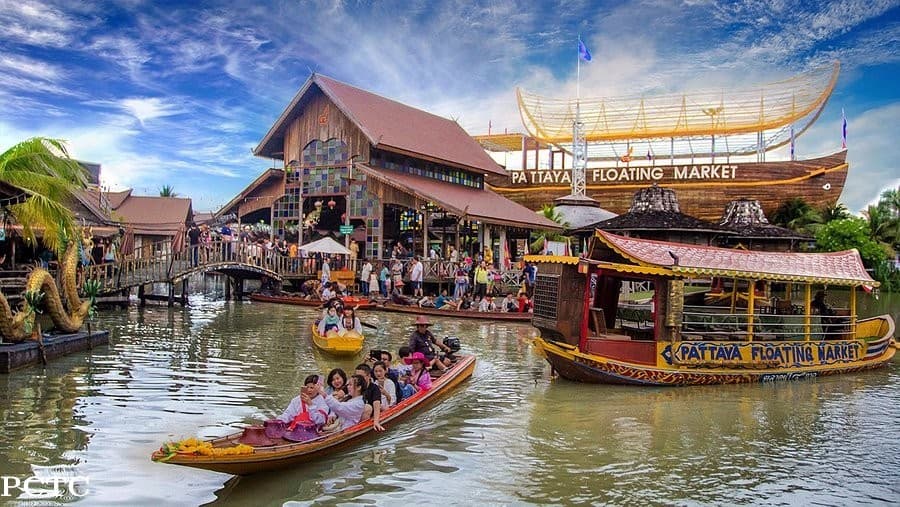 Pattaya Floating Market wooden stilt houses over water representing the four regions of Thailand — boats and street food