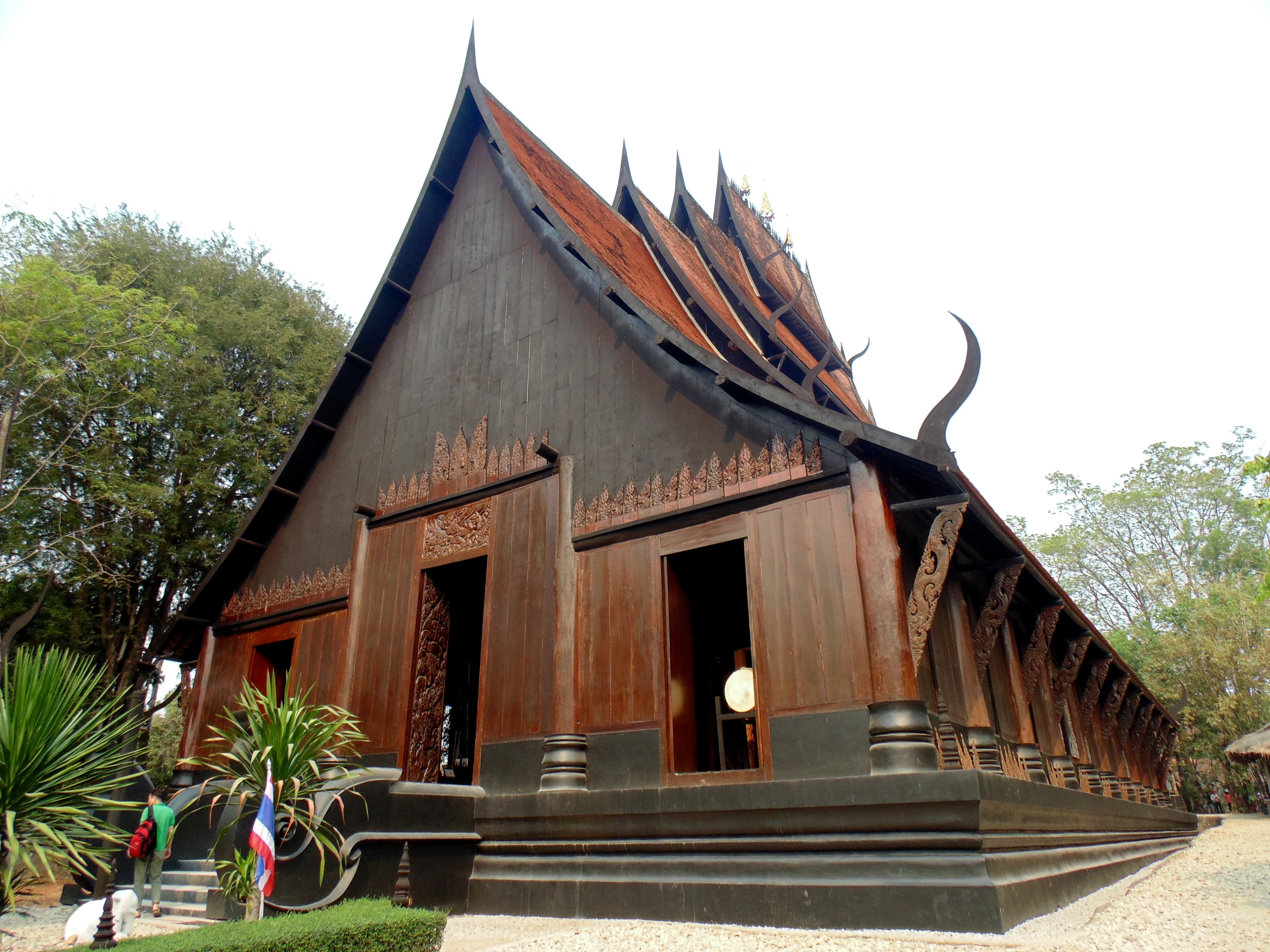 Baan Dam Black House Museum Chiang Rai — dark wooden buildings filled with animal skulls bones and dark sculptures by Thai National Artist Thawan Duchanee