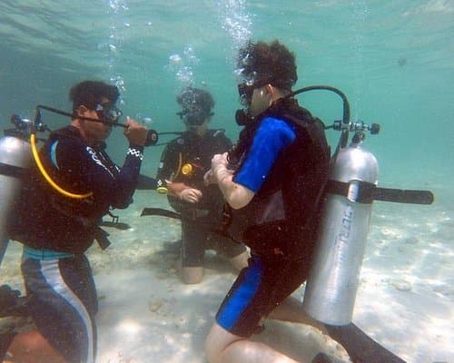 PADI instructor guiding a beginner Discover Scuba diver in Pattaya