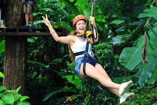 Zipline rider launching from a treetop platform at Hanuman World Phuket Chaofa Road Thailand