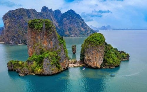 James Bond Island Ko Tapu 20-metre limestone needle rock Phang Nga Bay viewed from Khao Phing Kan beach Phuket speedboat tour 2026