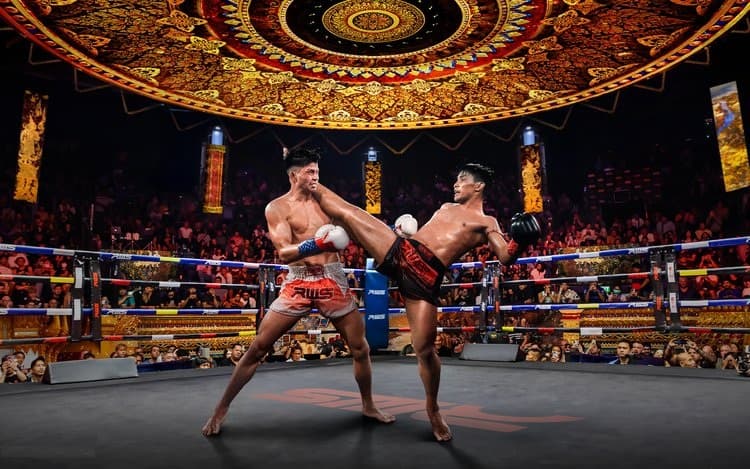 Rajadamnern Stadium Bangkok ring under the lights during a Muay Thai fight night with a full crowd