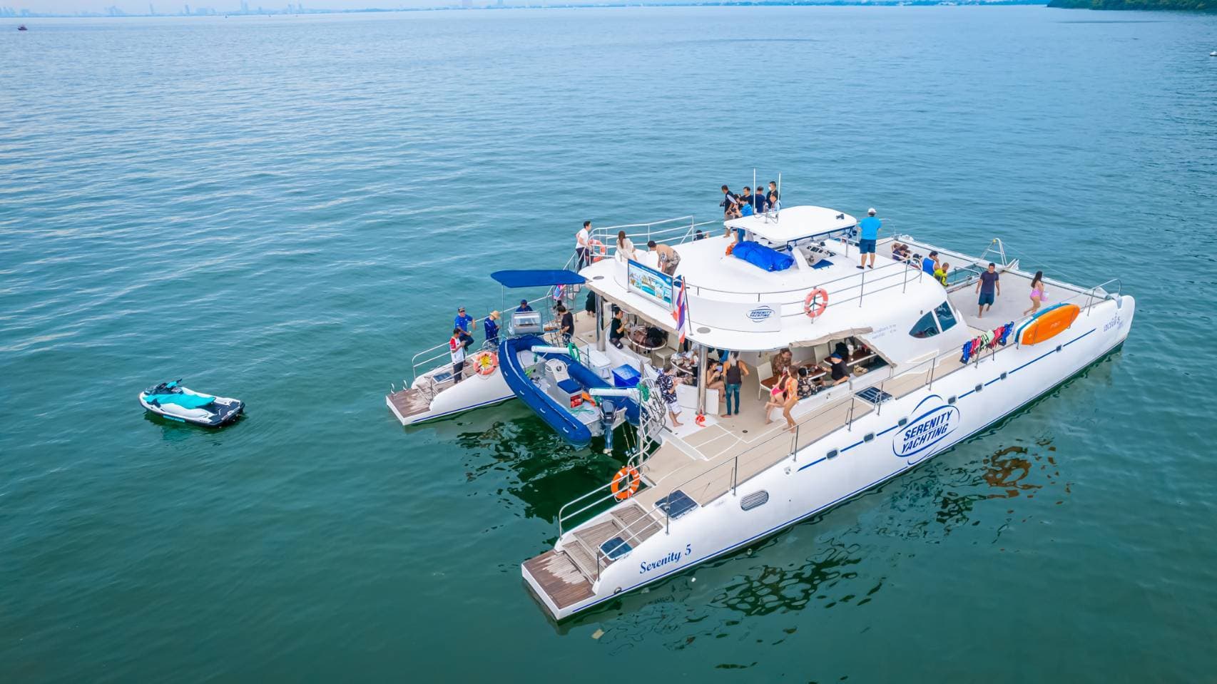 Aerial view of the Serenity catamaran with jet ski and the Pattaya skyline on the 3 island cruise