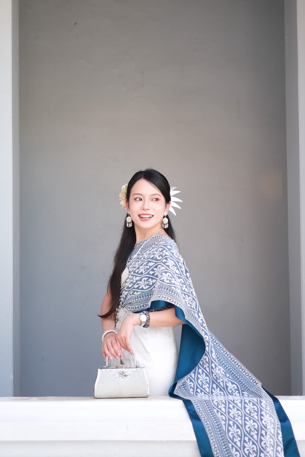 Grey and teal Thai traditional dress with silver accessories at Wat Arun Bangkok