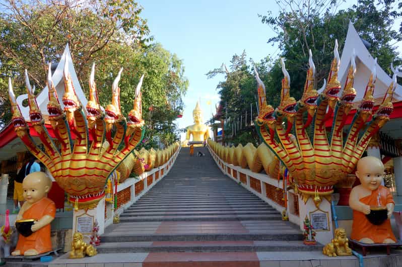 The 18-metre golden Buddha Luang Pho Yai surrounded by temple grounds at Wat Phra Yai, Pattaya