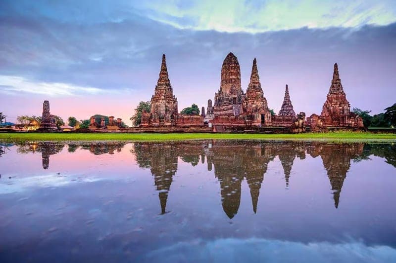 Ayutthaya UNESCO ruins private day trip from Bangkok — ancient temple chedis at sunset