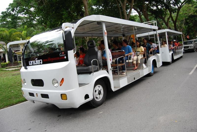 Private van parked inside the zoo grounds beside an animal enclosure