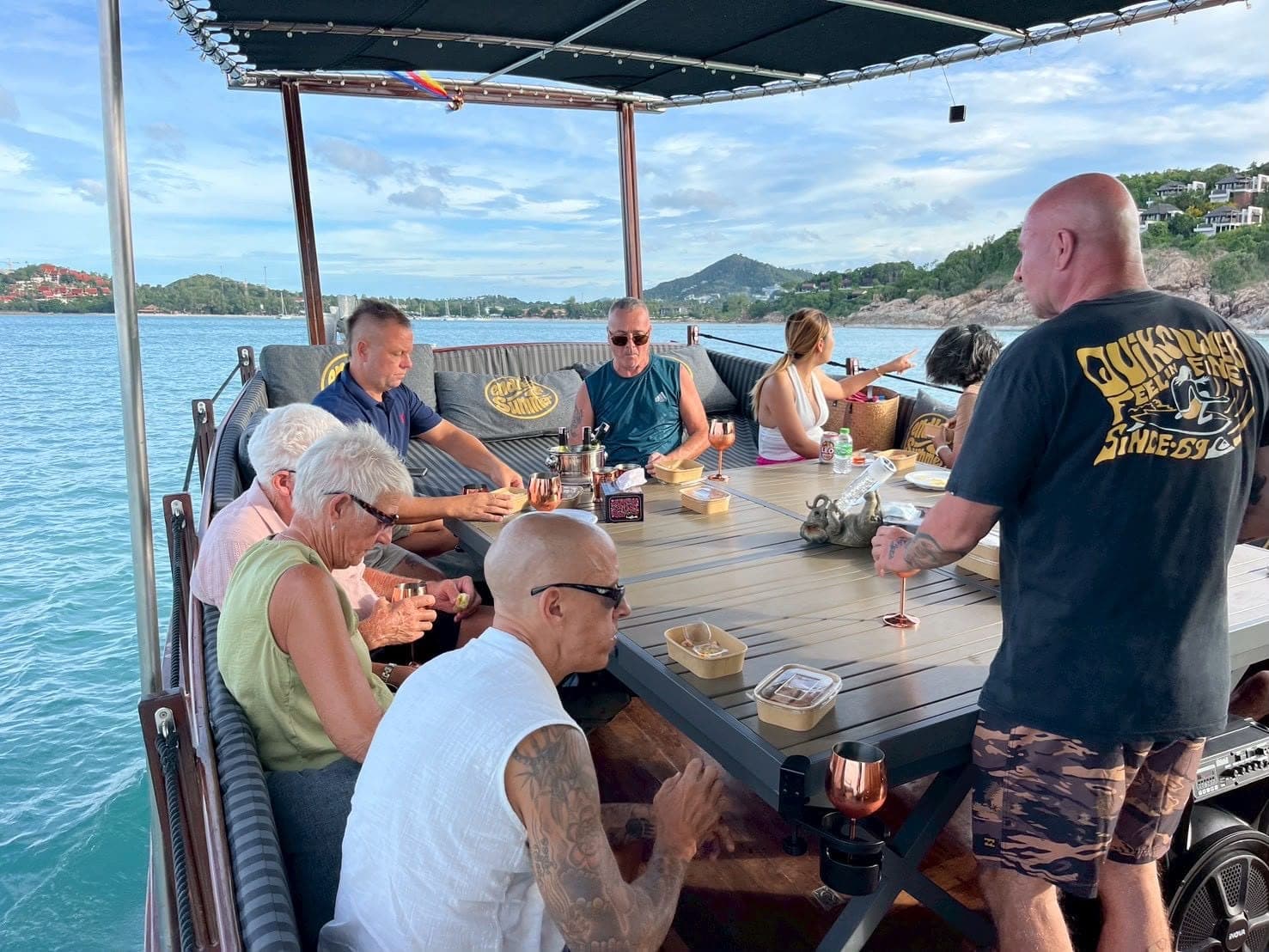 Guests dining on deck along the Koh Samui coastline aboard the Endless Summer trawler