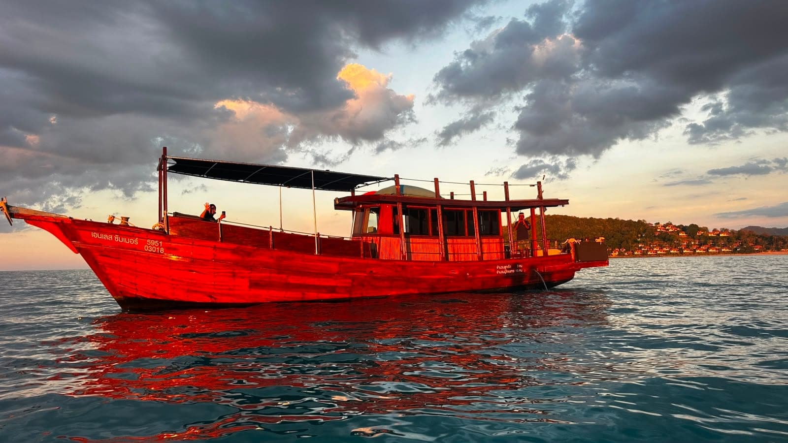 Endless Summer wooden trawler glowing red at sunset on a Koh Samui evening cruise