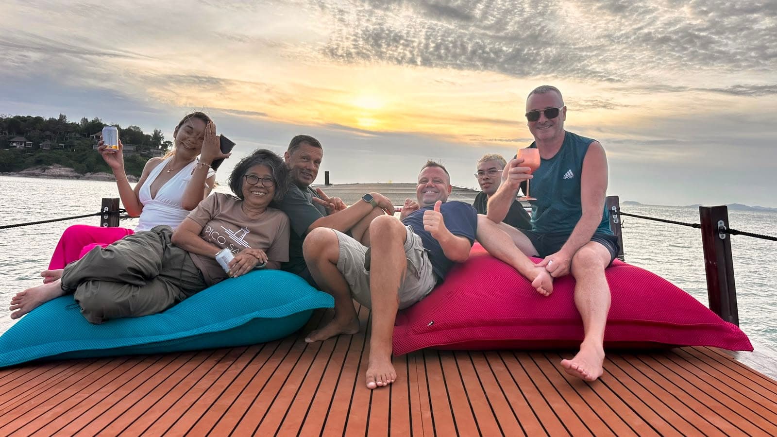 Guests relaxing on giant deck cushions at sunset aboard the Endless Summer Koh Samui
