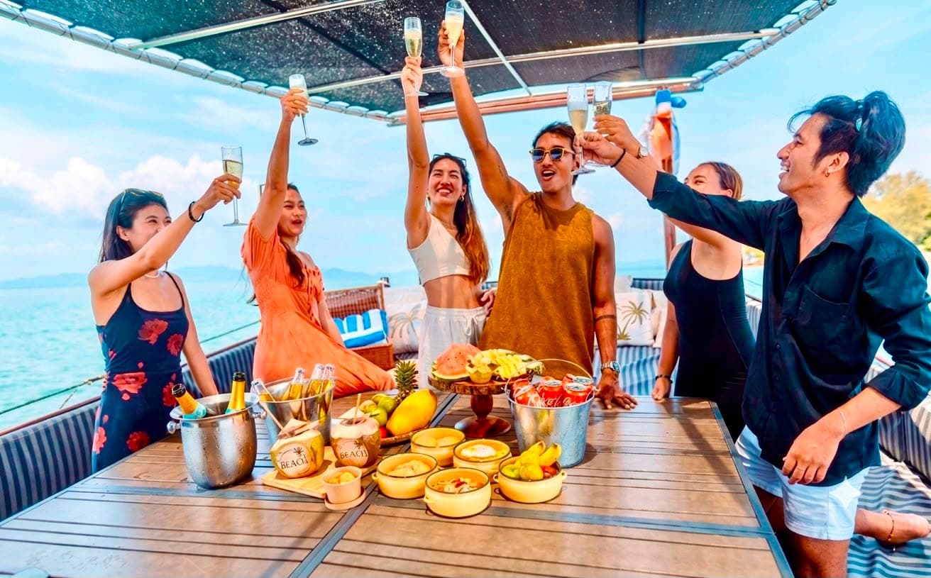 Champagne toast over gourmet lunch and fruit spread on deck Koh Samui snorkeling boat trip