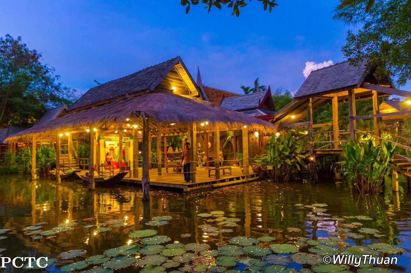 Siam Niramit Phuket 100-Year Thai Village traditional wooden houses at dusk