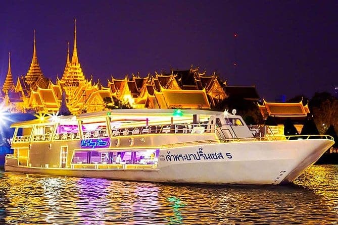 Grand Palace Bangkok illuminated at night seen from the Chao Phraya Princess cruise