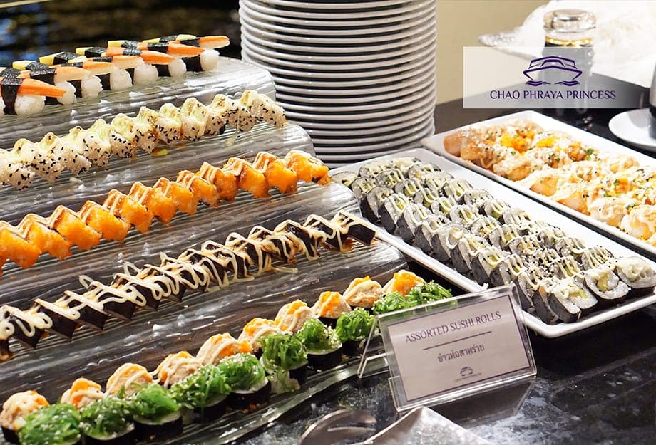 Japanese corner with sashimi and assorted sushi rolls on the Chao Phraya Princess cruise Bangkok