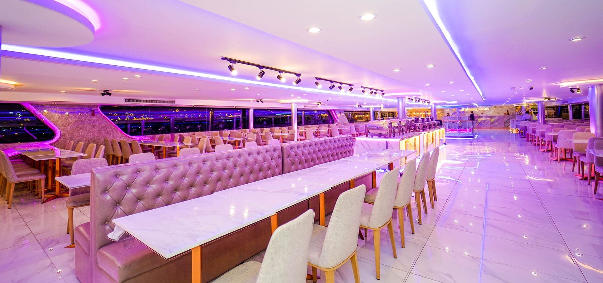 Air-conditioned interior deck with panoramic windows on the Luxury White cruise Bangkok
