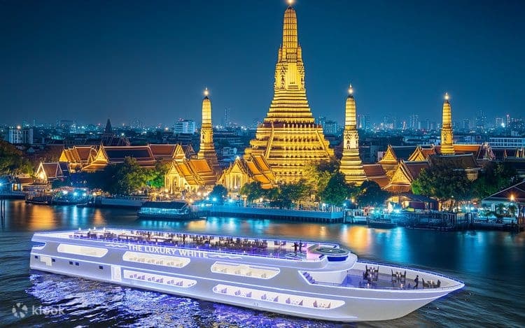 Wat Arun Temple of Dawn illuminated at night viewed from the Luxury White cruise