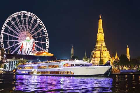 Grand Palace Bangkok illuminated at night seen from the Royal Princess Cruise Chao Phraya River