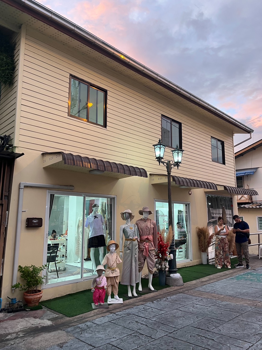 Thai costume rental studio near Wat Arun Bangkok with traditional outfits on display
